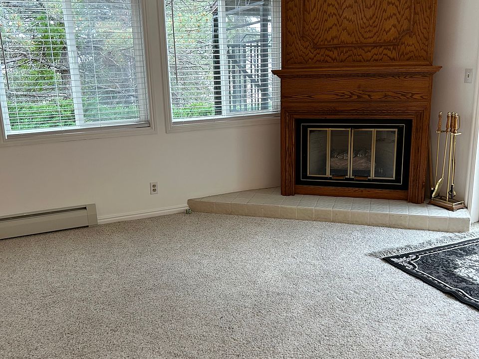 Living room with gas fireplace and new blinds