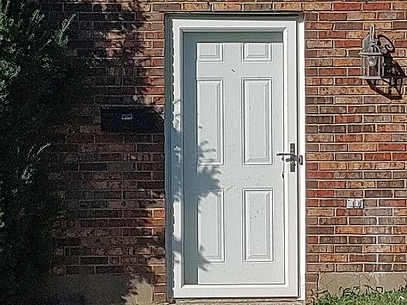 Front door with new aluminum and glass storm door