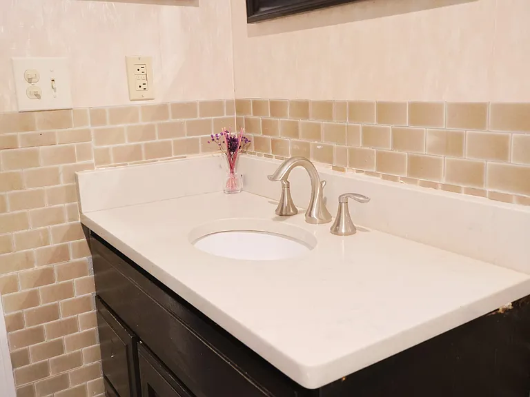 Bathroom _ Fully Renovated Within the Past Year, Featuring a New Tub, Toilet, Sink, Flooring, Wallpaper, and Cabinetry.