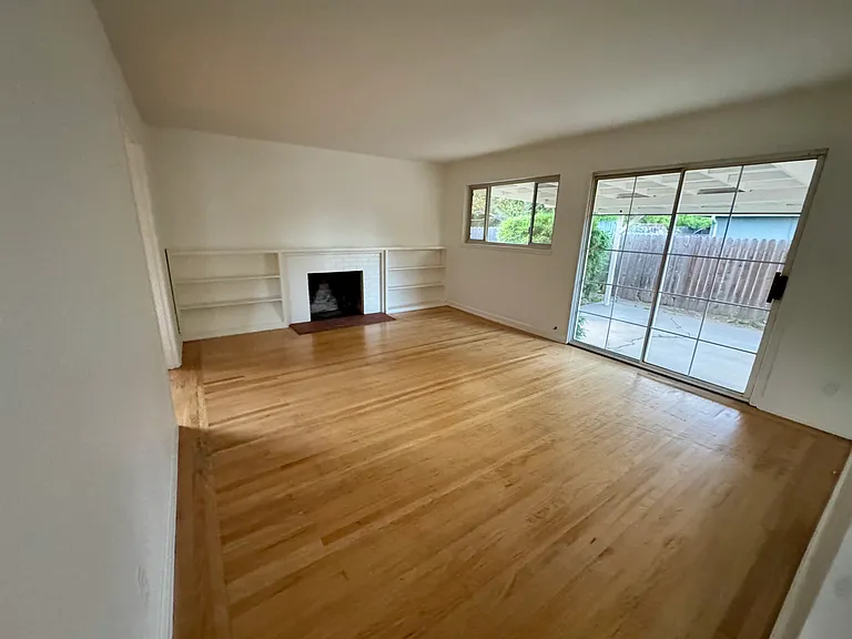 lovely and bright living room with sliding door to outdoor patio