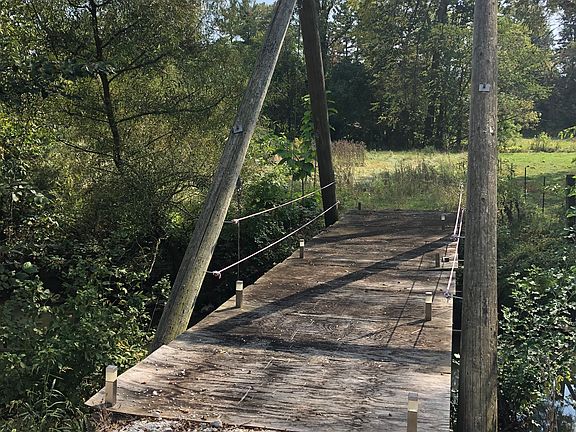 Footbridge to side lot. 