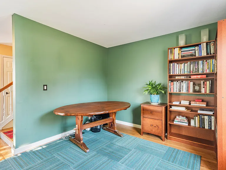 The spacious main floor office or den, perfect for working from home or creating a cozy tv space.
