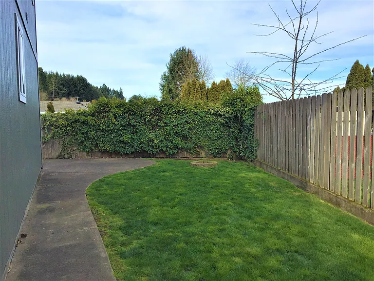 Fully fenced back and side yard, includes a fire pit