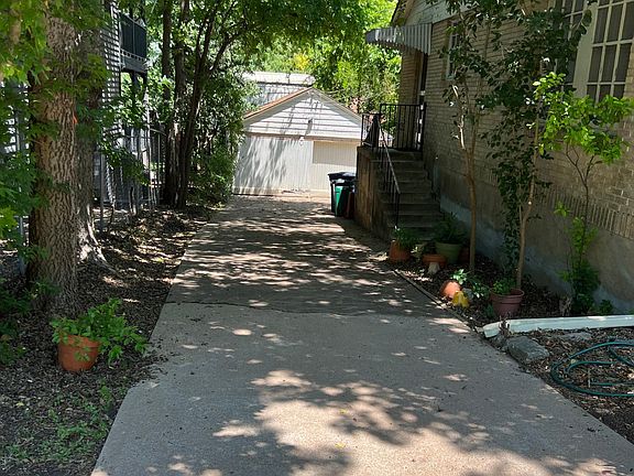 Driveway leading to garage and back entrance to house