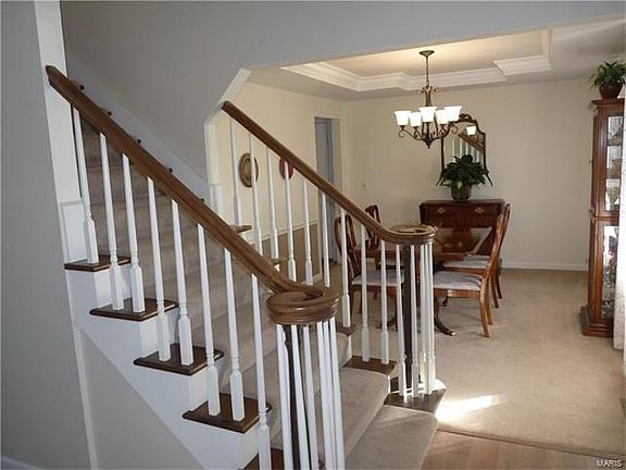 Gorgeous entry with wood laminate flooring & open tread stairway.