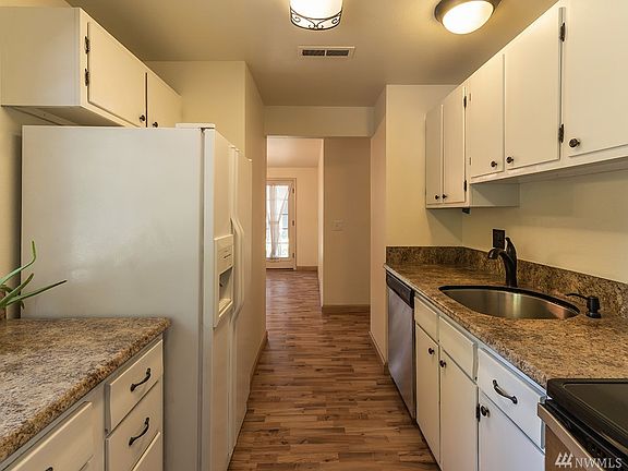 Kitchen looking into dining room and french doors to back yard