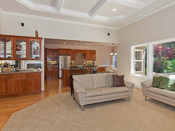 The open kitchen overlooks a large Great Room with stunning views of the gorgeous backyard.