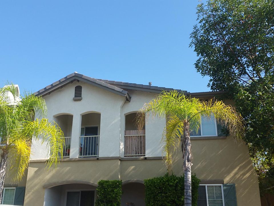 exterior stairway in center of pod, covered porch/walkway goes to entryway.