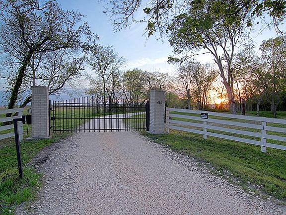  Gated entry for added privacy. Boundary of property fronting highway is full of trees as well.