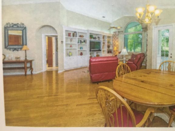 Living room with beautiful new hardwood floors and built in cabinets.