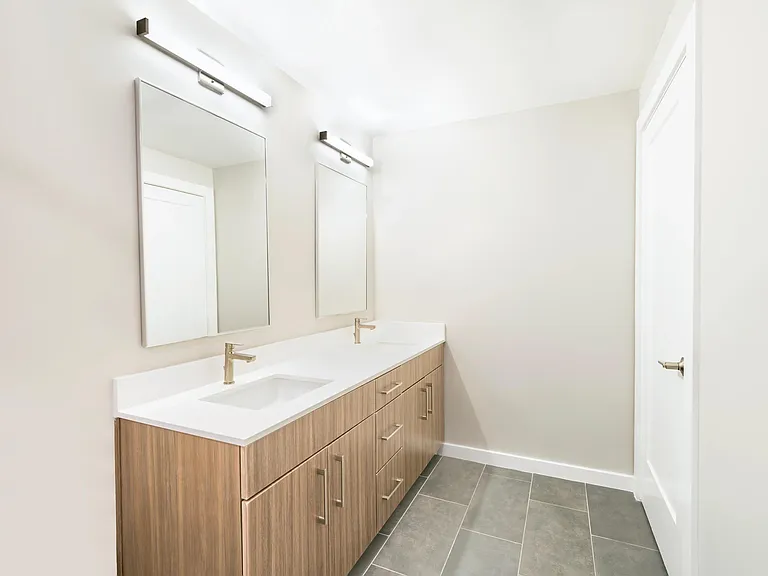 Dual sinks, quartz finishes, and elevated style make this bathroom feel like a private retreat.