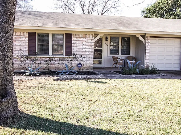 The front of the house has 2 pecan trees and roses that bloom in the Spring.