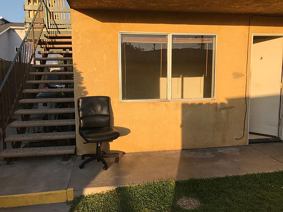 assigned parking space under stairway adjacent to the unit