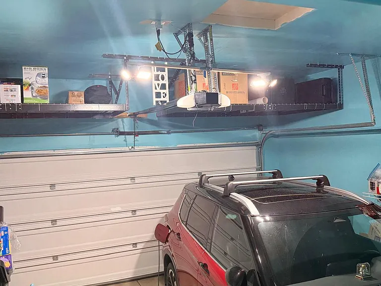 Garage designed for maximum storage efficiency, featuring durable turquoise all_weather paint, expansive overhead racks for bulk items, and reinforced side shelving that keeps tools, supplies, and everyday essentials neatly organized and easy to reach.