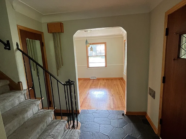 front entry with slate floor leading into dining room