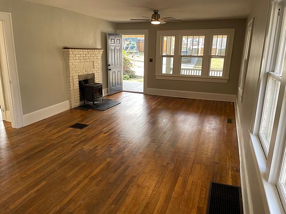 Enter into living room w great light and jotul wood stove.