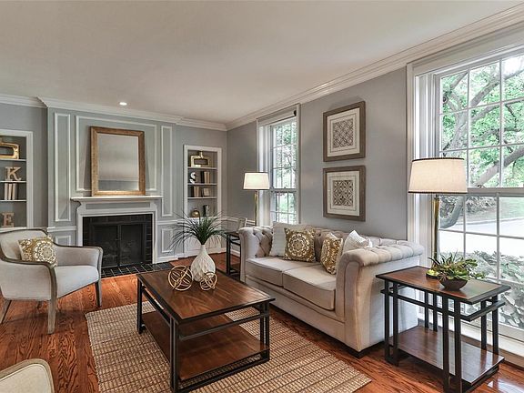 Living room features a vented gas fireplace and built-in bookshelves.