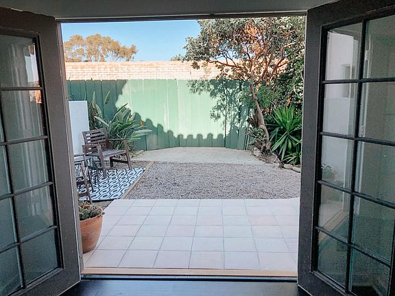 French Doors that open up from living room/dining room into private front yard