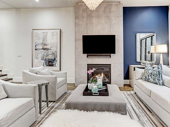 The gas fireplace flanked in natural stone anchors your formal living space. Sophisticated designer details such as the paint contrast here continue throughout the home.