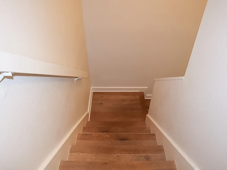 Stairway with hardwood steps.