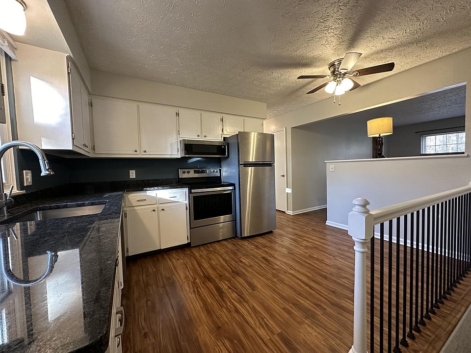 Photo of kitchen taken from the top of the stairs.