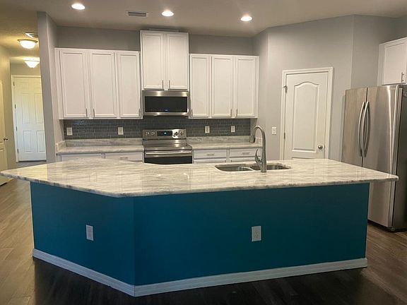 Large kitchen with granite counter top, breakfast bar and stainless steel appliances
