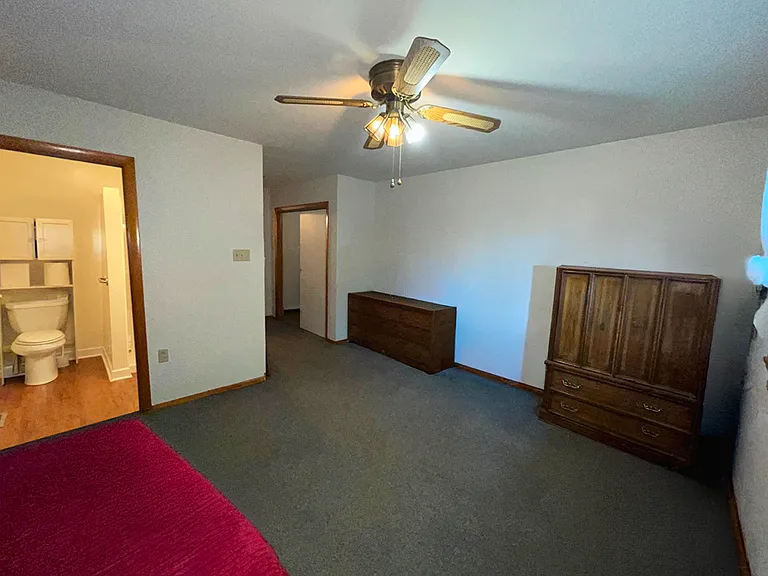 1st floor Primary bedroom with a bathroom, large closet and view of the backyard