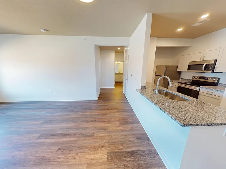 The Pyle features an open-concept living space and kitchen with granite countertops, a breakfast bar, and stainless steel appliances. The Pyle features an open-concept living space and kitchen with granite countertops, a breakfast bar, and stainless steel