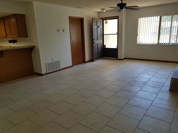 Front door and garage entry. Large windows with lots of light. Matching tile throughout house.