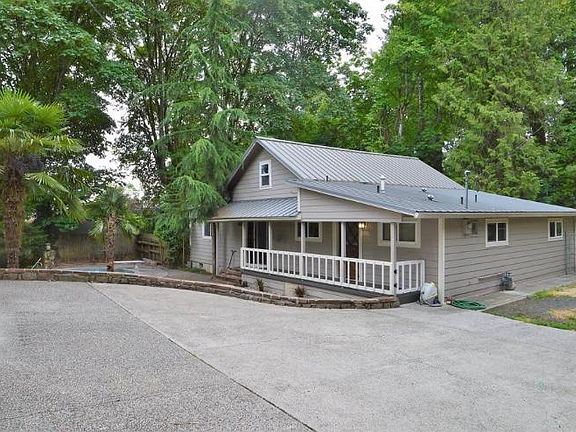 Back of the house. Deck overlooks the pool