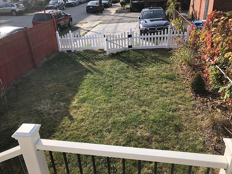 Backyard from Deck (shows the parking pad that has two spots in Tandem for Unit 2)