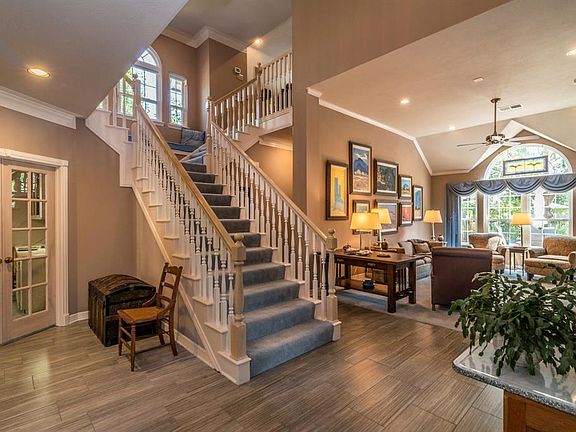 Double doors at left open to private study. This room may also be used as a second bedroom downstairs, there is an adjacent full bath. Open and inviting floor plan is light-filled.
