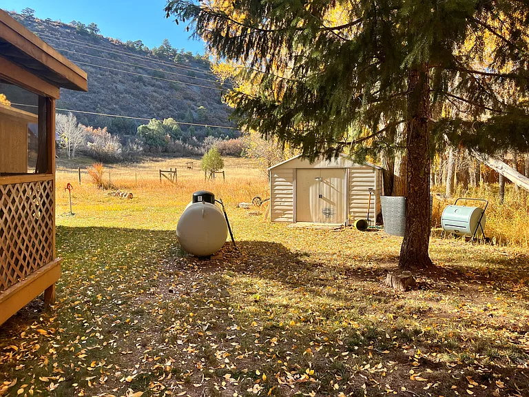 exterior - 2nd side yard, propane tank, and shed with view of shared property