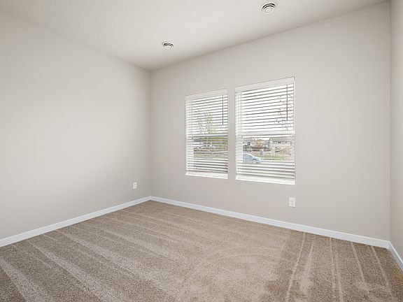 The master bedroom is spacious with large windows.