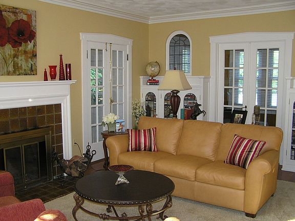 Living room has fp and beautiful leaded glass windows and bookshelf doors.