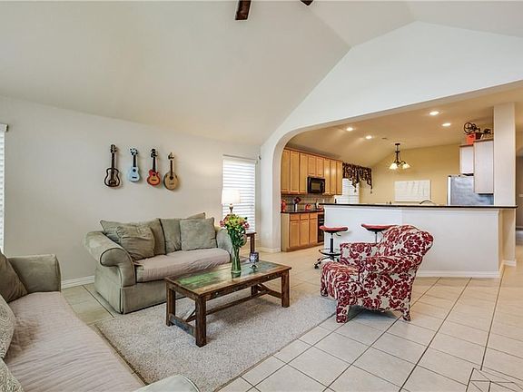 High ceilings and an open kitchen design is very easy to see the tv from the kitchen and watch the kids play outside while you are busy inside.