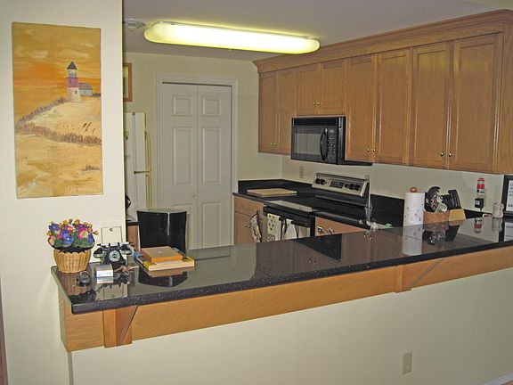 Open kitchen with raised granite snack counter. Allows for view from kitchen