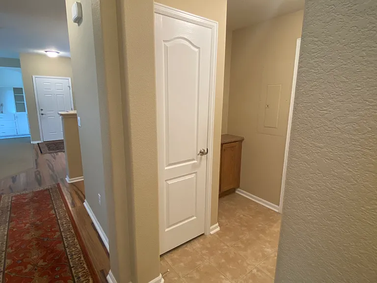 Alcove with coat closet and storage cabinet