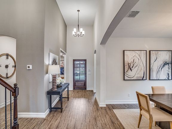 Model Representation - Inviting foyer entry showcases the formal dining room