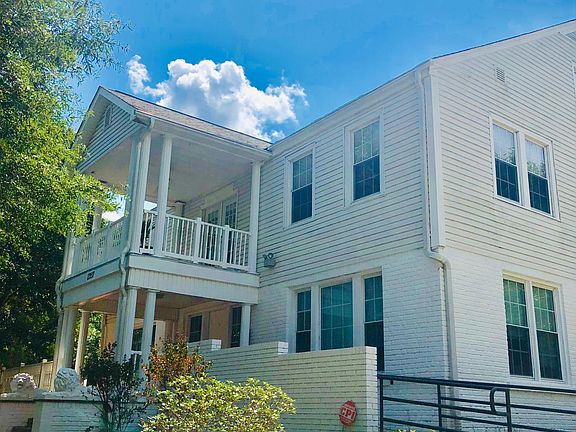 A beautifully preserved Southern-style historic home, featuring architectural character, a landscaped front garden, and a private, boutique living experience with only four residences in the building.