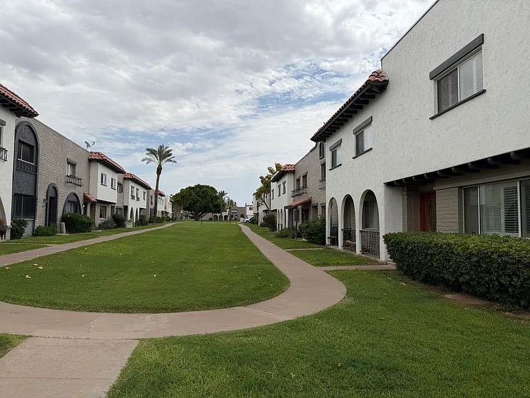 Front of Townhome - Large grass areas and walking paths.