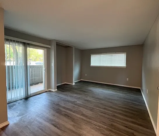 Bright living room with large sliding glass doors leading to private patio