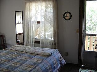 One of two Bedrooms with door to back deck area