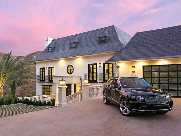 Expansive driveway leading up to this picturesque French style Chateau in Beverly Hills, California