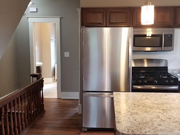 Brand new kitchen with stainless steel appliances and gas ra