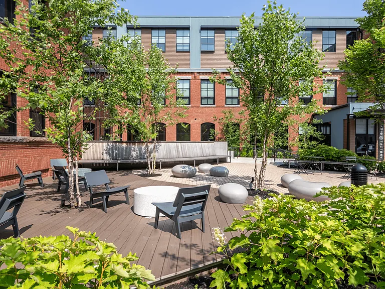 Outdoor courtyard with ample seating and beautiful landscaping