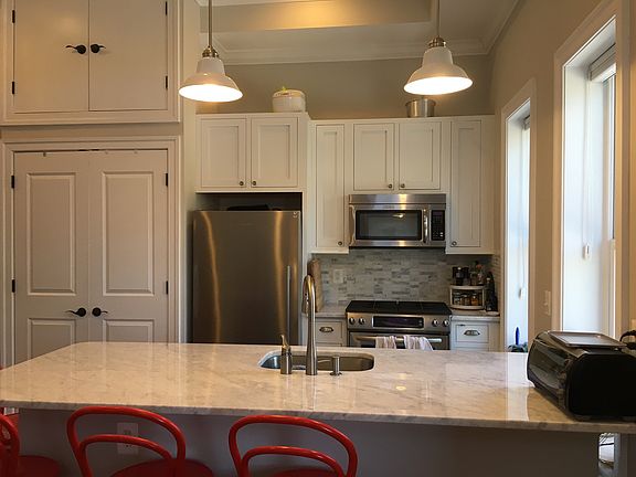 Kitchen with stainless steel appliances and marble counterto