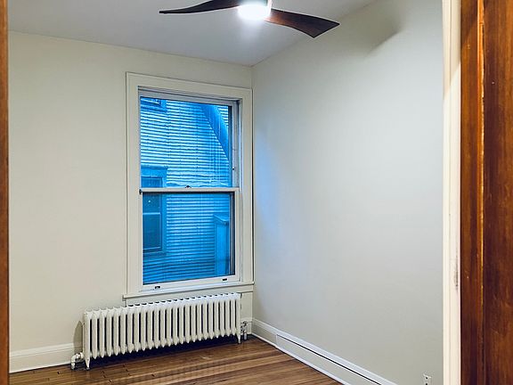The spacious bedroom has a new fan & natural light.