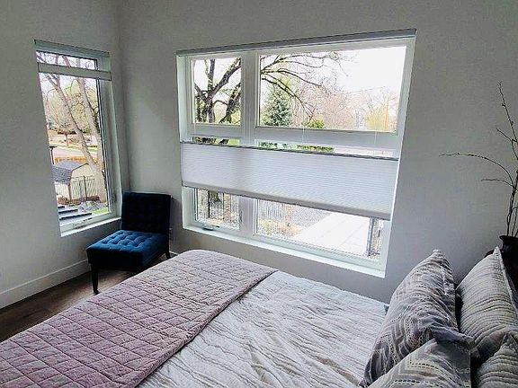 Bedroom has privacy shades but view of park across street. Wooded beautiful lot convenient to everything and secured with electronic gate and fully fenced in.