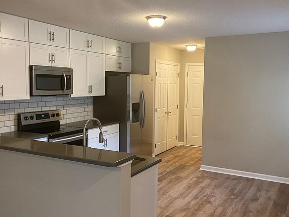 Roomy kitchen with breakfast bar, large pantry and room for a kitchen table.